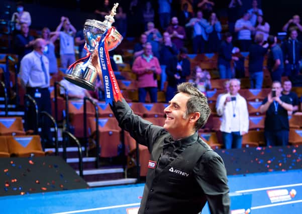 Back on top: Ronnie O’Sullivan holds aloft the Betfred World Championship trophy for the sixth time in his career in front of the few hundred or so fans permitted into the Crucible last night.  (Picture: Benjamin Mole/WST/Shutterstock)