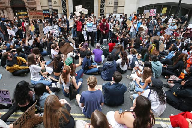 People take part in a protest outside the Department for Education, London, in response to the downgrading of A-level results.