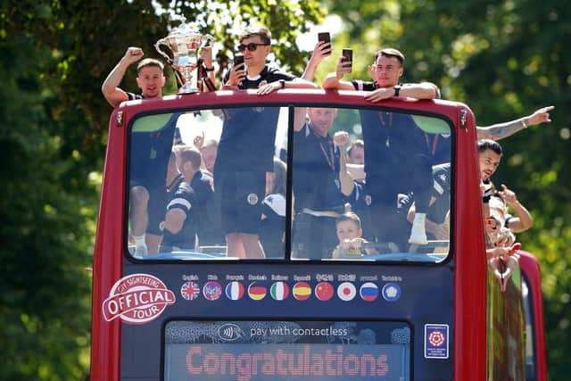 Harrogate Town AFC's Josh Falkingham (left) and Ryan Fallowfield (right) are seen celebrating during an open top bus tour around Harrogate. (Picture:: Morgan Harlow/PA Wire)