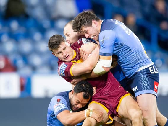 Huddersfield Giants' Innes Senior is tackled by St Helens' Joseph Paulo, James Roby and Louie McCarthy-Scarsbrook. (Allan McKenzie/SWpix.com)