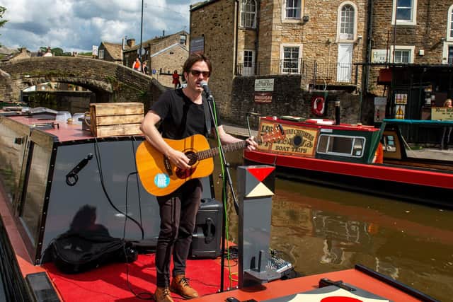 Singer/songwriter Alaister Griffin performs on a Narrow Boat in Skipton Canal Basin as part of his Tour of Social Distance.