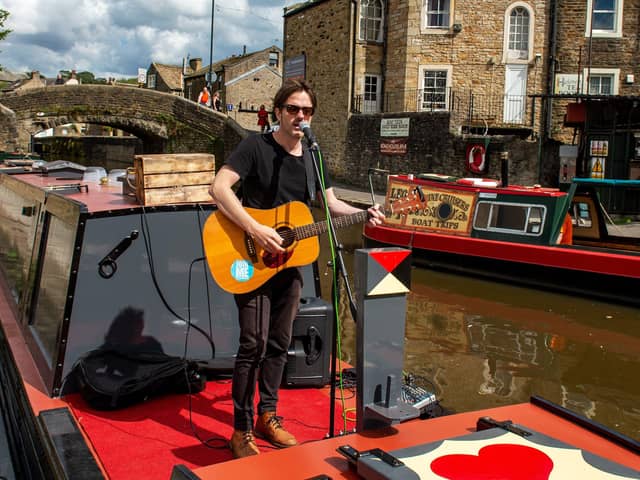 Singer/songwriter Alaister Griffin performs on a Narrow Boat in Skipton Canal Basin as part of his Tour of Social Distance.