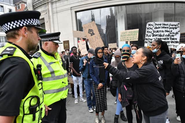 Police and protesters at a Black Lives Matter demonstration in Bristol, as a survey shows 65% of BAME people feel there is bias against them within police forces