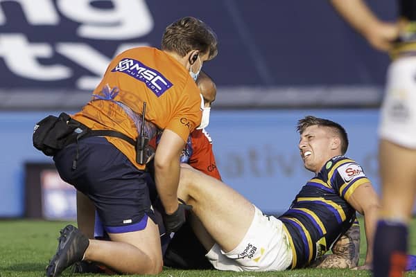 Leeds Rhinos' Alex Mellor receives treatment on field for a knee injury against St Helens. Picture: Allan McKenzie/SWpix.com.