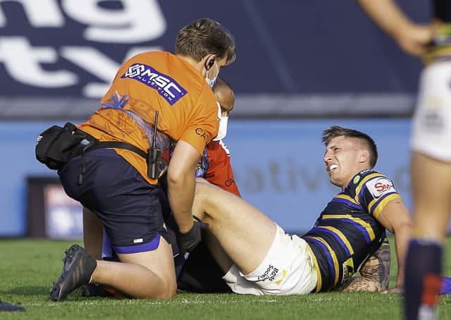 Leeds Rhinos' Alex Mellor receives treatment on field for a knee injury against St Helens. Picture: Allan McKenzie/SWpix.com.