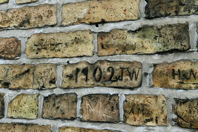 Markings carved into the brickwork from regulars over the years Picture: Jonathan Gawthorpe