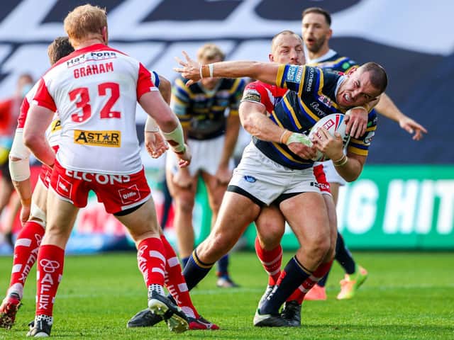 Leeds Rhinos' Cameron Smith is tackled by St Helens' James Roby. (Alex Whitehead/SWpix.com)