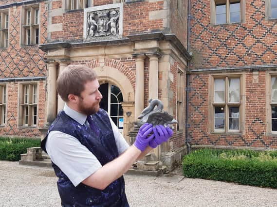Director of Kiplin Hall and Gardens, James Etherington, pictured outside of the historic house museum holding an antique swan shaped ice-cream mould.