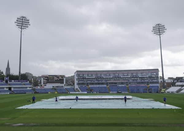 Bleak scene: Yorkshire's groundstaff rush to put the covers on as rain falls heavily at Heaidngley on Saturday. Picture: SWPix
