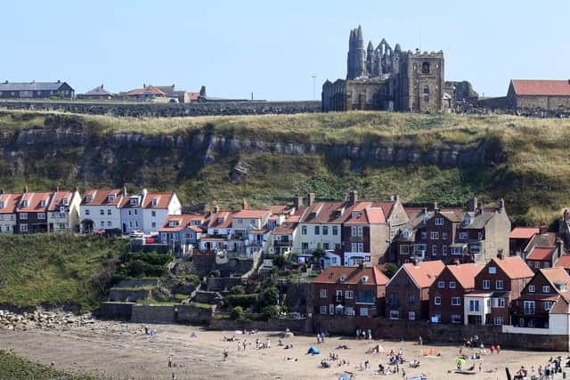 People enjoying the beach with the abbey in the background. (Gary Longbottom).