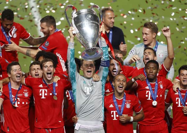 Bayern's goalkeeper Manuel Neuer lifts the trophy after Munich won the Champions League final. (Matthew Childs/Pool via AP)