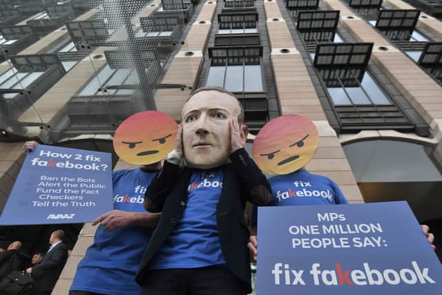 A Mark Zuckerberg figure with people in angry emoji masks outside Portcullis House in Westminster, London ahead of Mike Schroepfer, Chief Technology Officer at Facebook, appearing before a DCMS inquiry into fake news in 2018. Picture: Victoria Jones/PA Wire
