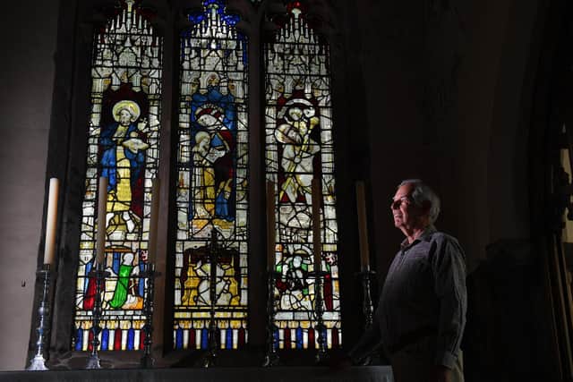 David Tichener picture by one of the stain glass windows to be repaired by the National Lottery Heritage fund. Photo credit: Simon Hulme/JPIMediaResell