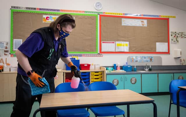 Joshua Lee disinfects tables at Queen's Hill Primary School in Costessey near Norwich, as they prepare to reopen. Picture: Joe Giddens/PA Wire