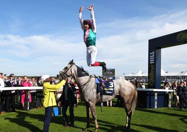 TIMELY BOOST: Jockey Frankie Dettori performs his traditional celebratory leap after winning last year’s St Leger at Doncaster on Logician. Picture: George Wood/Getty Images.