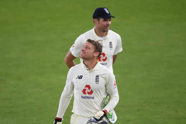 WAITING GAME: Jos Buttler and James Anderson walk off as bad light stops play during day four at the Ageas Bowl. Picture: Stu Forster/Getty Images