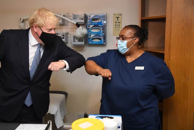 Prime Minister Boris Johnson elbow bumps Lead Nurse Marina Marquis during a visit to Tollgate Medical Centre in Beckton in East London.