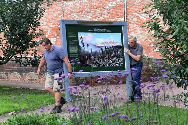 Ivor Beckwith and Craig Riley bring one of the pictures into the gardens.Picture by Simon Hulme.