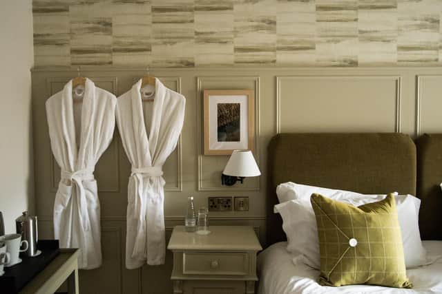The panelling here is decorative and also functional as it has been used to hide the wiring for bedside lamps
