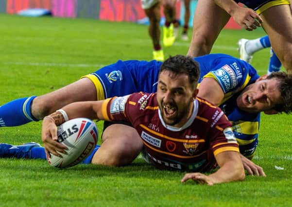 Huddersfield's Tom Holmes in action against Warrington.  Picture Bruce Rollinson