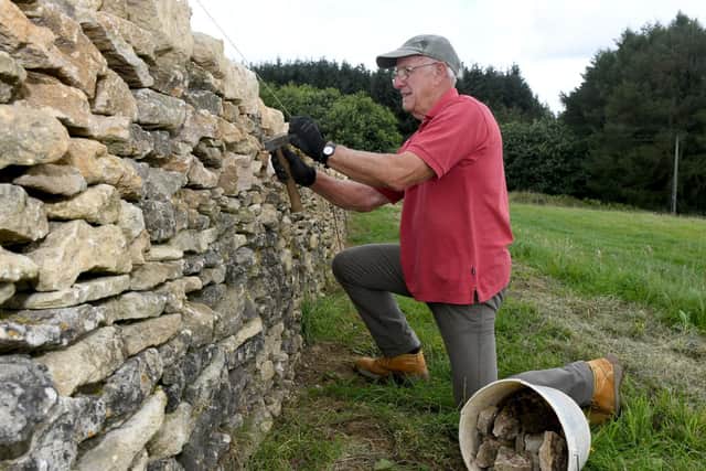 Former Navy Captain turned dry stone waller, Peter at work on his friend John Robinson's wall.
