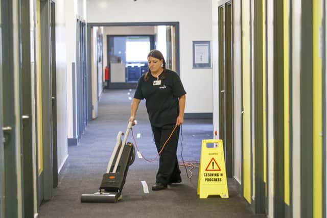A woman cleans at Outwood Academy Shafton in Barnsley, South Yorkshire, as preparations are made before the start of the new term.