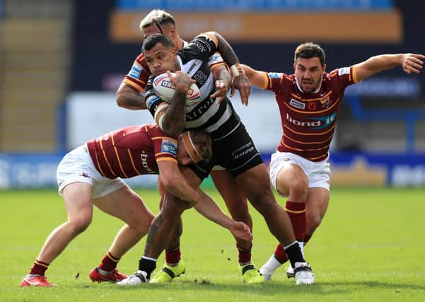 Hull's Manu Ma'u (centre) tackled by Huddersfield's Adam O'Brien, Ken Edwards and Jake Wardle during the Betfred Super League match at the Halliwell Jones Stadium, Warrington. PA Photo. Picture date: Sunday August 30, 2020. See PA story RUGBYL Huddersfield. Photo credit should read: Mike Egerton/PA Wire. RESTRICTIONS: Editorial use only. No commercial use. No false commercial association. No video emulation. No manipulation of images.