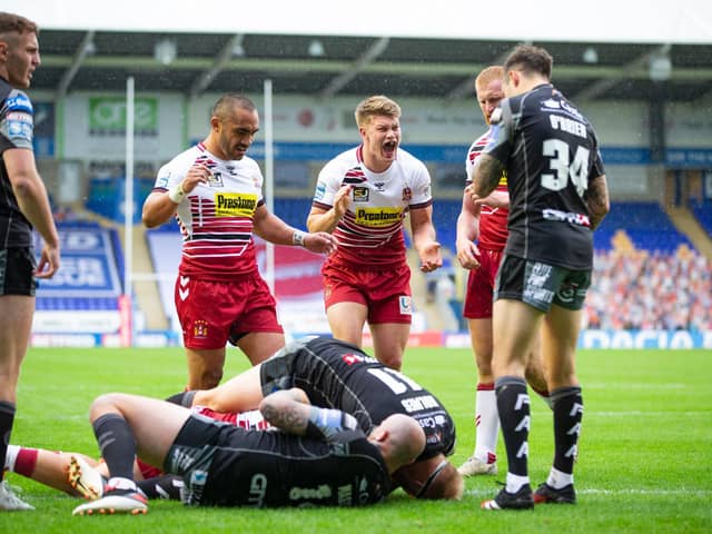Delighted Wigan Warriors forward Morgan Smithies, centre, celebrates Sam Powell's try in his side's win over Castleford Tigers. (Isabel Pearce/SWpix.com)