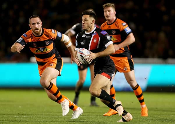 future employee: Niall Evalds, centre, playing for Salford against Castleford last season, will line up against them again tonight before joining them in 2021. (Picture: PA)