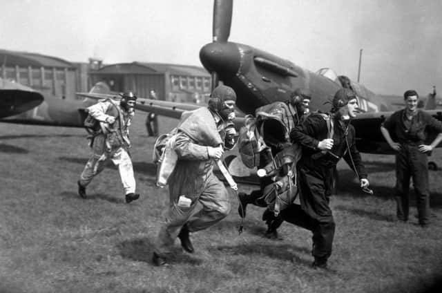 Pilots of No 19 Squadron, Royal Air Force Fighter Command scramble to their wooden, two-blade, fixed-pitch propellered Supermarine Spitfire MkI fighter planes for a training exercise on 4th May 1939 at RAF Duxford airfield in Cambridgeshire, England. (Photo by Fox Photos/Hulton Archive/Getty Images)