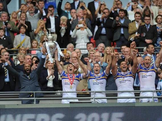Leeds Rhinos' Jamie Jones-Buchanan and Kevin Sinfield raise the 2015 Challenge Cup after beating Hull KR at Wembley (PIC: STEVE RIDING)