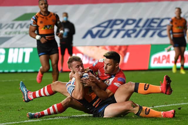 Castleford Tigers' Danny Richardson battles with Niall Evalds before getting the ball down to start his side's comeback (PIC: JONATHAN GAWTHORPE)