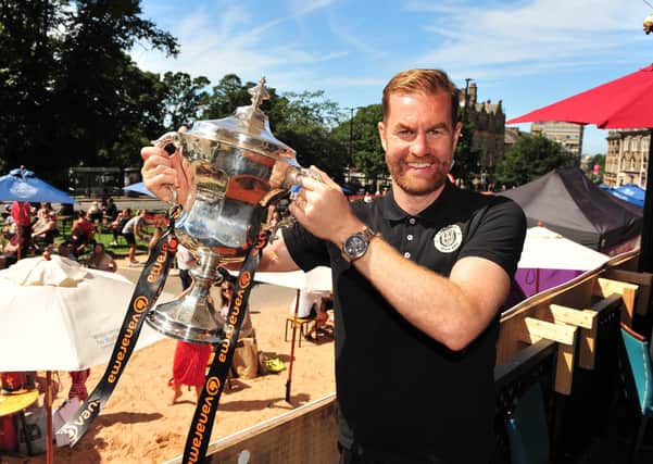 Proud moment: Harrogate Town manager Simon Weaver with the National League play-off trophy (Picture: Gerard Binks)