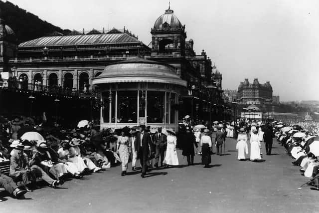 circa 1913:  Tourists crowd the promenade near the bandstand at the North Yorkshire coastal resort of Scarborough.  (Photo by Alfred Hind Robinson/A H Robinson/Getty Images)