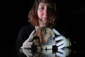 Curator of archaeology Martha Jasko-Lawrence with a Canopic jar lid. Photo: Simon Hulme