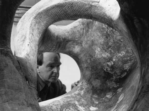 Henry Moore examining his massive sculpture Reclining Figure in 1953. Photo by Chris Ware/Keystone Features/Getty Images