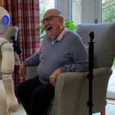 Pepper the robot meets care home resident, Peter. Picture: University of Bedfordshire