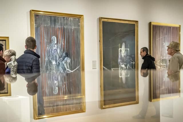 Members of the public, reflected in a display cabinet, view work from Francis Bacon's Screaming Popes series at Ferens Art Gallery in Hull