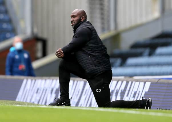 STEADY HAND: Doncaster Rovers manager Darren Moore takes a knee before the Carabao Cup match at Ewood Park. against Blackburn Rovers. Picture: Richard Sellers/PA