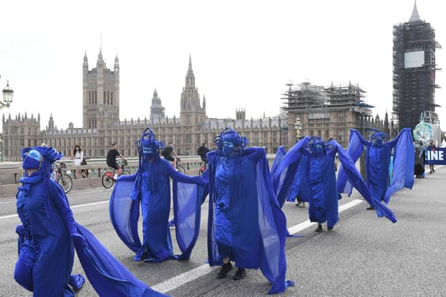Extinction Rebellion protesters march across Westminster Bridge.