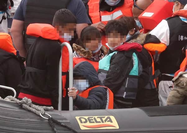 Young children amongst a group of people thought to be migrants as they are brought into Dover, Kent, by Border Force officers following a small boat incident in the Channel.