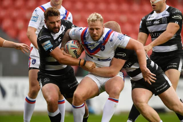 Wakefield's Joe Westerman is stopped by the Hull defence.