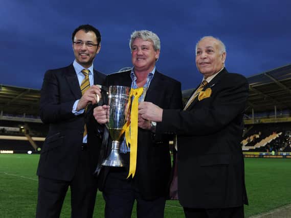 May 2013: Hull City manager Steve Bruce, centre with owners Ehab Allam, left and Dr Assem Allam with the Championship Runners up trophy at the promotion party celebrating the teams rise into the Premier League at the KC Stadium