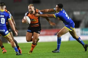 FRUSTRATING TIMES: 
Castleford Tigers' Paul McShane battles with Warrington's Luis Johnson.
 Picture: Jonathan Gawthorpe