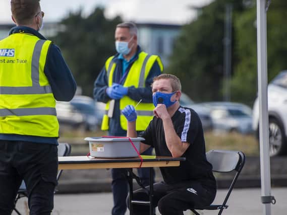 Some people have found getting a covid test easier than others. Here a man swabs his mouth at an NHS Covid Testing facility in Bolton town centre (Getty Images).