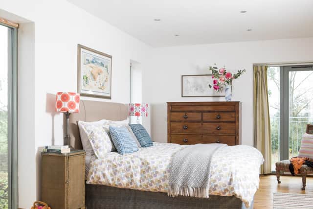 The bedroom was extended at the same time as the kitchen below it. The bed, from Barkers of Northallerton, is flanked by old lamps given a modern twist with new shades made by neighbour Georgia Wilkinson.