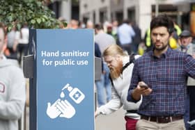 A man uses a public hand sanitiser in Leeds city centre