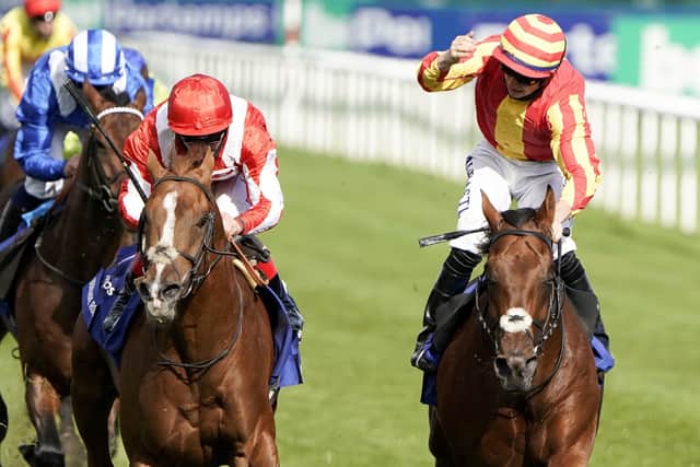 Galileo Chrome ridden by jockey Tom Marquand (right) celebrates winning The Pertemps St Leger Stakes at Doncaster. Picture: Alan Crowhurst/PA