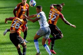 AERIAL: Kurtis Guthrie and Dylan Mottley-Henry challenge Colchester United's Cohen Brammall for the ball