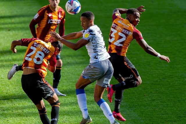 AERIAL: Kurtis Guthrie and Dylan Mottley-Henry challenge Colchester United's Cohen Brammall for the ball